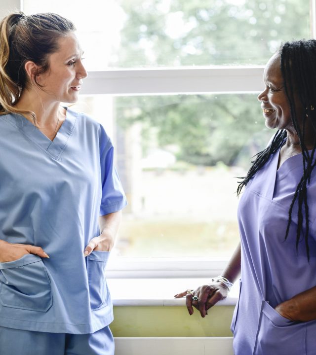 Nurses having a conversation in the hospital hallway